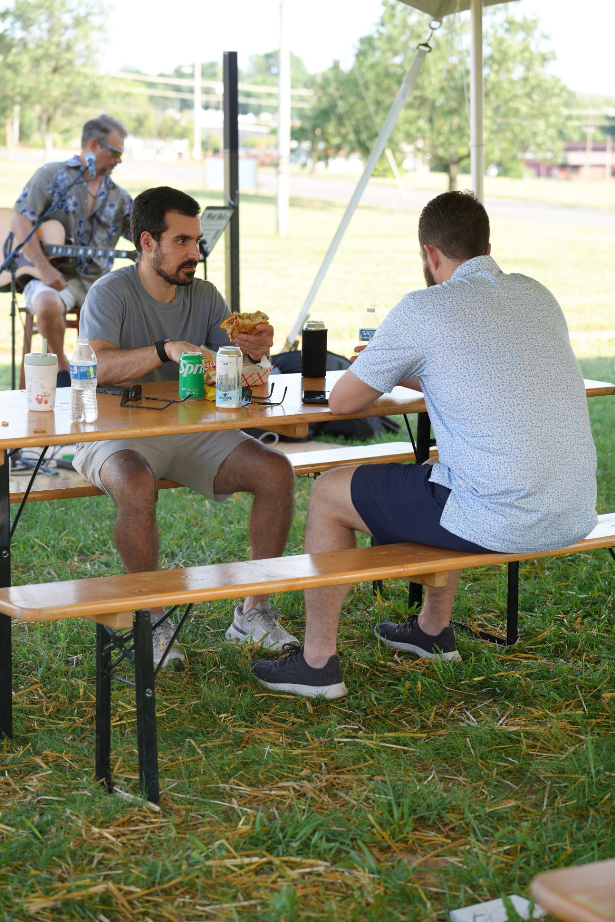 Friends sharing a meal under the tent
